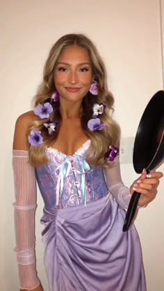 a woman in a purple dress holding a frying pan