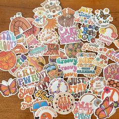 many different stickers on a wooden surface