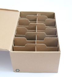 an open cardboard box filled with lots of cards and folders on top of a white surface