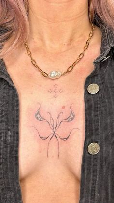 a woman has a tattoo on her chest