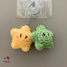 two crocheted keychains with faces on them