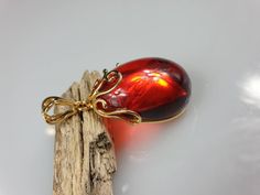 Deep Red amber pendant. Perfect stunning ruby red teardrop shape. Gold plated pendant (with stamping-hallmark). High quality. Teardrop shape elegant pendant. All natural parts, not plastic. Weight: 14.00 gr Pendant size: 5.5 x 2.6 cm MATCHING Earrings: https://www.etsy.com/uk/listing/912802337/ruby-red-amber-earrings-gold-plated?ref=shop_home_active_4&frs=1 This item was made of natural Baltic Amber. All the amber used in my jewelry is collected in my home country Lithuania. I sell only genu Solar System Jewelry, Molecule Necklace, Science Jewelry, Planet Necklace, Dainty Diamond Necklace, Custom Initial Necklace, Tiger Eye Jewelry, Family Tree Necklace, Tigers Eye Necklace