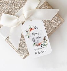 a gift wrapped in glitter paper with a white bow on it's neck and tag that says sip hooray