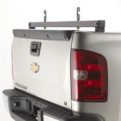 the back end of a silver truck with two hooks on it's tailgates