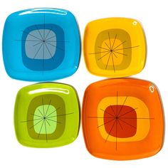 four square plates with different colored designs on the sides and one has a hole in the middle