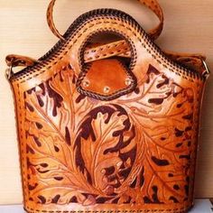 a brown leather purse sitting on top of a table