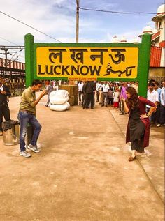 people standing in front of a sign that says lucknow