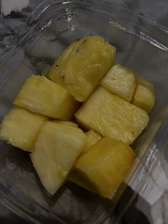 sliced pineapples in a plastic container on a table