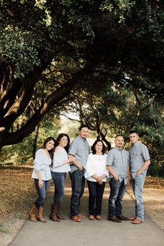 a group of people standing next to each other under trees