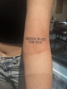 a woman's arm with the words vienna waits for you tattooed on her left arm