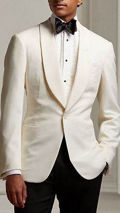 Man wearing a white tuxedo blazer with black pants. He is wearing a black bowtie and a white collard shirt to complete the look. Classy Men Outfits Gentleman Style, Classic Suits For Men, Dapper Men Outfits, Black Tuxedo Wedding, Classic Suits, Suit Prom, Prom Suit