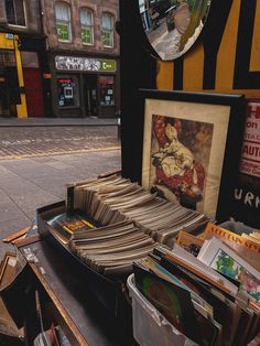 there are many books on the table and in front of it is a framed picture