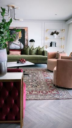 a living room filled with lots of furniture and a painting on the wall behind it