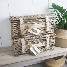 two wicker baskets sitting on top of a table next to a potted plant