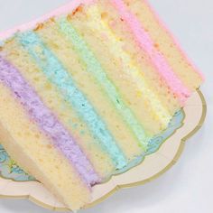 a slice of rainbow cake sitting on top of a plate