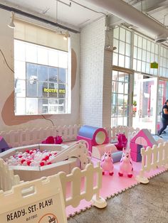 the children's play area is decorated in pink and white