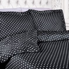 a black and white polka dot comforter on a bed