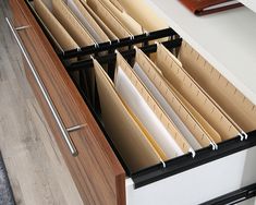 an open file cabinet filled with files and folders