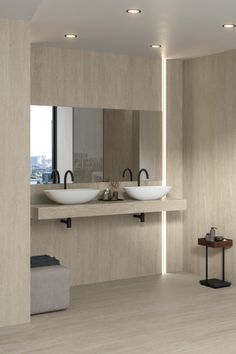 a modern bathroom with two sinks and mirrors