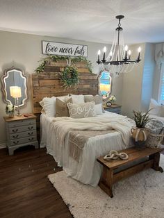 a bed room with a neatly made bed and a chandelier hanging from the ceiling