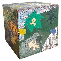 a multicolored box with stars and snowflakes painted on it's sides