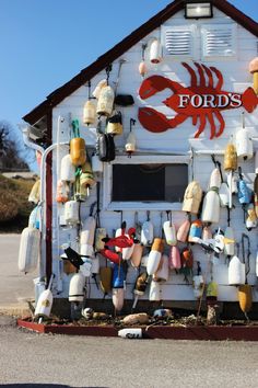 a white building with lobsters and buoys on it