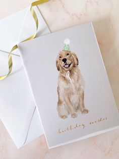 a card with a watercolor drawing of a golden retriever wearing a birthday hat