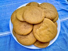 a white plate topped with cookies on top of a blue table cloth