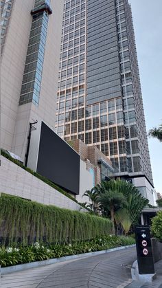 a tall building with a flat screen tv mounted to the side of it's face