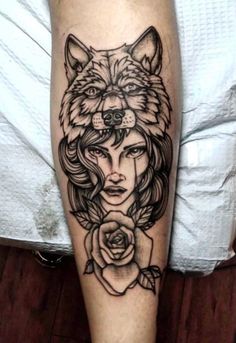 a woman's leg with a wolf and rose tattoo on the side of her leg