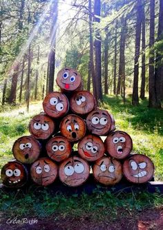 a pile of logs with faces drawn on them