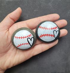 two handmade baseball buttons with hearts on them