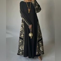 Black Double Sided Jalabiya With Light Gold Embroidery & Light Gold Piping. The Jalabiya Is A Double A-Cut Cut. Size Medium, 54” Black Kaftan With Dupatta, Designer Long Kaftan For Eid, Designer Black Kaftan For Eid, Traditional Evening Kaftan With Dupatta, Black Designer Kaftan, Traditional Evening Kaftan With Mirror Work, Black Traditional Wear With Mirror Work For Evening, Designer Black Kaftan With Resham Embroidery, Anarkali Abaya For Eid Evening