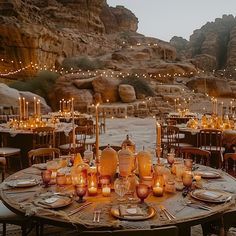 a table set up with candles and plates