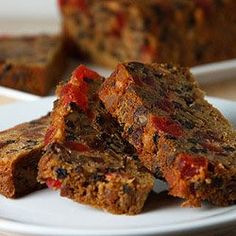 several pieces of fruitcake on a white plate