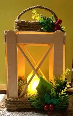 a lighted lantern sitting on top of a table next to a basket filled with flowers