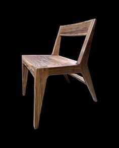 a wooden chair sitting on top of a black background