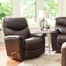 two recliners sitting in front of a window with a lamp on top of it