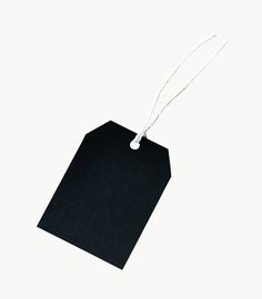 an empty black tag hanging from a string