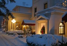 a large white house covered in snow at night