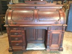 an old wooden desk with many drawers