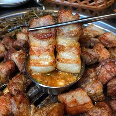 there are some meats being cooked in a bowl