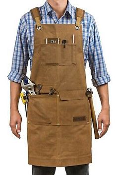 a man wearing an apron with tools in his pocket and holding a wrench on his hip