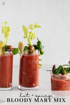 three glasses filled with different types of food and garnishes on a table