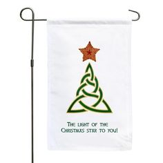 a white flag with a christmas tree on it and the words, the light of the christmas star to you