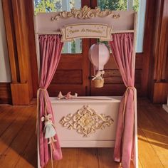 a toy bathtub with pink curtains and decorations