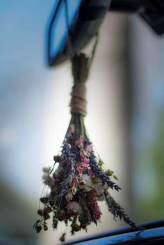 dried flowers hanging from the roof of a car