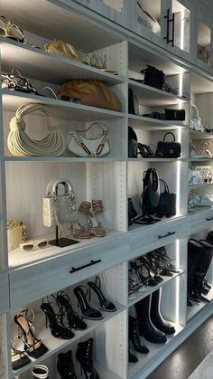 there are many shoes and purses on the shelves