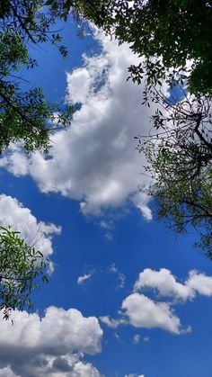 the sky is filled with clouds and trees