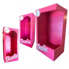 two pink boxes with the words barbie on them and one has a window in it